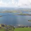 General oblique aerial view of St Mary's looking towards Glimps Holm and Churchill Barrier No. 2 with Burray and South Ronaldsay beyond, taken from the NNE.