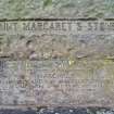 Detail of inscriptions on the S face of the stone and on its plinth.