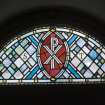 Interior. E wall, detail of stained glass fanlight