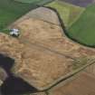 Oblique aerial view of the cropmarks of the barrow, looking NNE.