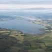 General oblique aerial view looking across Nigg Bay along the Cromarty Firth with Invergordon in the middle distance, looking WSW.