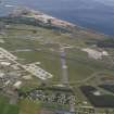 Oblique aerial view of Kinloss Airfield with Findhorn village beyond, looking NW.