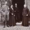 Group of four people standing in doorway.
Titled: 'Aikenshaw. November 1904. Mr and Mrs Campbell of Peton; Mr W S Turnbull; and Mrs Jameson'. 
