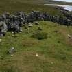 View from W of the probable hut-circle (HU24NE 179) underlying the later enclosure wall.