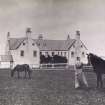 View of Balnakeil House showing woman and horses outside building.
Titled: 'Balnakeil'.
