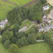 General oblique aerial view of the village centred on the church taken from the SSW.