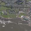 General oblique aerial view of the harbour area, centred on the lighthouse, taken from the E.