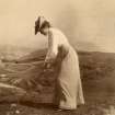 View of woman playing golf. 
Titled: 'F.J.T Braid Hills 1902'
