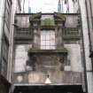 View of architectural decoration including masks and garland, above Meuse Lane.