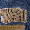 View of cross-slab fragment with spiral decoration (including scale)