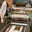 View of student working at a press within the case room of the Foulis Building