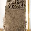 View of fragment of shrine post with carved interlace pattern (with scale)