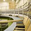 Interior. Curved wave tank building. View of modular work platforms, signal processing receivers (right). The platforms have been partially lifted to show how access to wavemakers achieved.