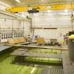 Interior. Curved wave tank building. View of modular work platforms, signal processing receivers (left) and the 'beaches' on the right