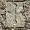 Detail of carved cross with round terminals on wall to S of decorative arch