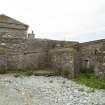 Outer courtyard to N of house, view of outbuildings from N