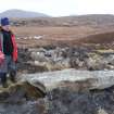 View from W showing the displaced capstone with Mr Stratford Halliday, RCAHMS.