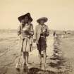 Photograph of two children on a beach, possibly outside Ayr. 
PHOTOGRAPH ALBUM NO 93 : THE STRANG COLLECTION, "SUNSHINE AND SHADE"
