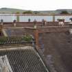Detail view from S of rooftops of  post-1913 foundry building from Walkway between Wings C and D
