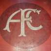 Interior. View of 'AFC' club crest set into the floor of the entrance foyer within the Main Stand of Pittodrie Stadium
