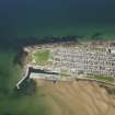 General oblique aerial view of Burghead, centred on the harbour, taken from the SSW.