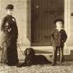 Blairgowrie, Woodside House
Photograph of Mrs Murray with dogs and small boy,  thought to be her son Edward, at main entrance of Woodside House.
Title: " Mrs [?] Murray & Family"
