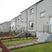 Street view showing the terraced housing at 30-39 Baptie Place, Bo'ness, taken from the North-West. The houses face on to the central, communal car parking area. This photograph was taken as part of the Bo'ness Urban Survey to illustrate the character of the Hillcrest and Brewlands Area of Townscape Character.