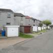 Street view showing partly terraced housing at Brick Row and Brewlands Avenue, Bo'ness, taken from the East. Each house is set back from the one before as they recede down the hill, and each has its own garage and direct access from the street. This photograph was taken as part of the Bo'ness Urban Survey to illustrate the character of the Hillcrest and Brewlands Area of Townscape Character.