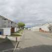 Street view showing partly terraced housing at Brick Row and Brewlands Avenue, Bo'ness, taken from the East. Each house is set back from the one before as they recede down the hill, and each has its own garage and direct access from the street. This photograph was taken as part of the Bo'ness Urban Survey to illustrate the character of the Hillcrest and Brewlands Area of Townscape Character.