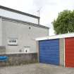 View showing the East elevation of 28 Roebuck Place and adjacent garages, Bo'ness, taken from the East. This photograph was taken as part of the Bo'ness Urban Survey to illustrate the character of the Hillcrest and Brewlands Area of Townscape Character.