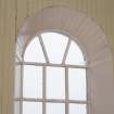 Interior. Detail of timber-boarded window jambs and round-arched window head.