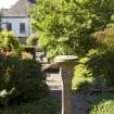 View from east with ball sundial and house in background.