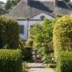 View from east showing avenue leading to sundial with house beyond.