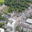 Oblique aerial view of Linlithgow High Street, centred on the market cross, taken from the WSW.