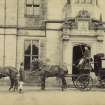 View of two drivers and carriage with four horses outside St Fort House.