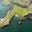 Oblique aerial view of Coroghan Castle and the pier on Canna, taken from the ESE.