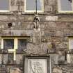 West entrance, detail of lion with flag and date shield (1874)