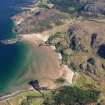 General oblique aerial view looking along the shore at the south end of Gruinard Bay with Gruinard House in the distance, taken from the SW.