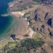 Oblique aerial view looking along the beach at the south end of Gruinard Bay, taken from the SW.