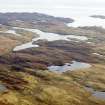 General oblique aerial view of the remains of  Dun Loch an Duna, the townships of Grimshader and Ceann Hurnavay, with associated mill and head dyke, Isle of Lewis, taken from the NW.