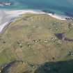 General oblique aerial view of the remains of the field system at Eoligarry, including the remains of a chapel and burial ground, looking towards the pier, Barra, taken from the SW.
