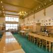 Interior. View looking along the length of the dining hall to the reception desk and servery.