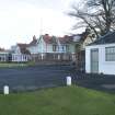 General view showing Starter's hut with Muirfield clubhouse beyond, taken from west.