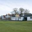 General view of Starter's hut and greenkeeper's store, with clubhouse beyond, taken from west north west.