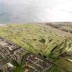Oblique aerial view of Carnoustie Golf Courses, taken from the NW.