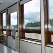 Detail. View of sample window bays with timber panelling within boardroom