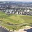 General oblique aerial view of Kings Links Golf Course with tower blocks adjacent, taken from the ENE.