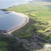 General oblique aerial view of Cruden Bay with the golf course adjacent, taken from the NE.