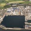 Oblique aerial view of HM Dockyard main basin Rosyth, taken from the SSW.