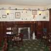 Interior. View within the public bar showing fireplace, bench seating fixtures and timber panelling, taken from west.